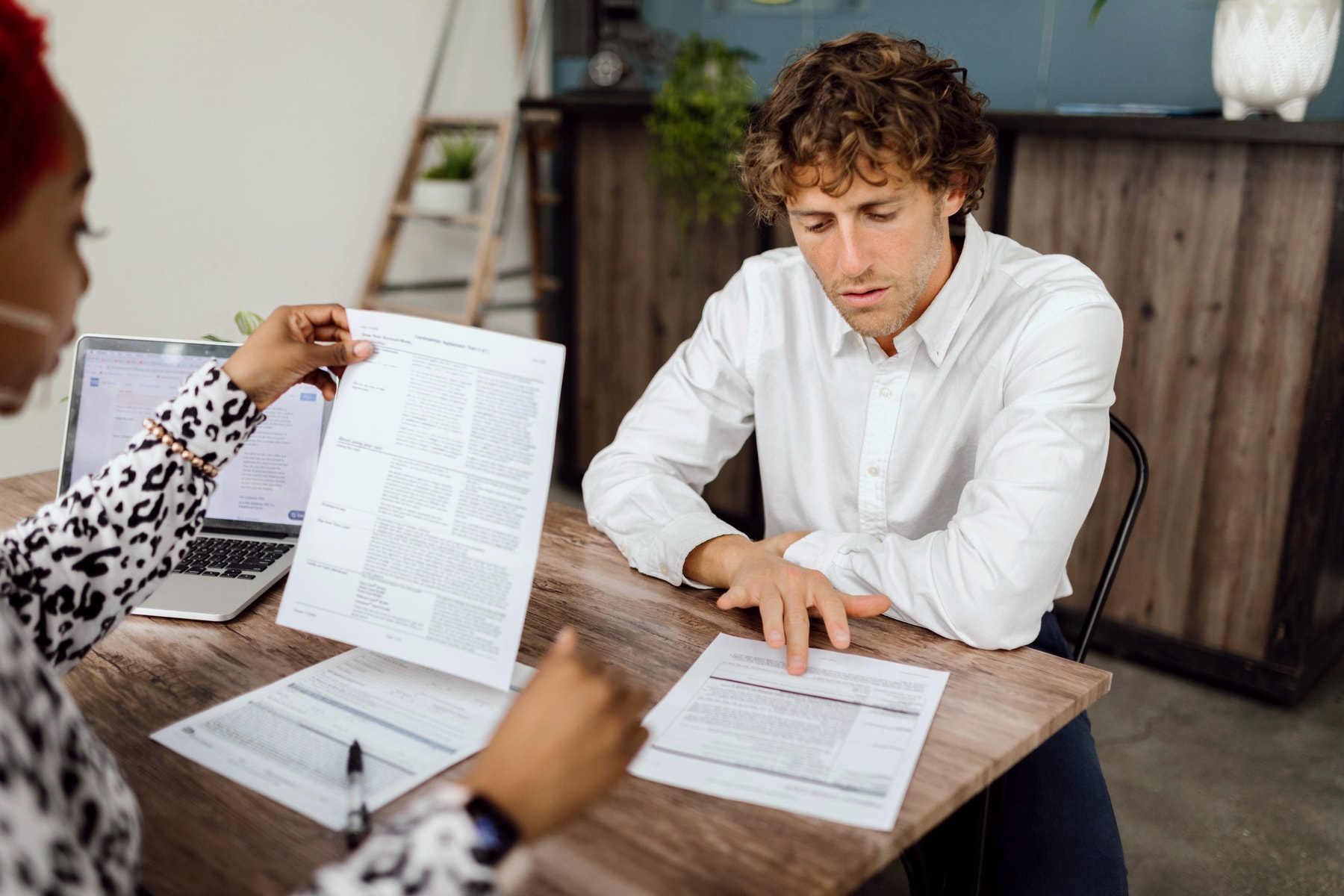 A broker going through policy documents with a client